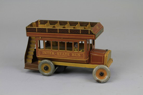 INTERSTATE DOUBLE DECKER BUS: Strauss, lithographed tin, brown version, bench seating on rooftop, disc wheels, clockwork driven, railing at rear entrance, a scarce find in this color. 10 1/2" l.