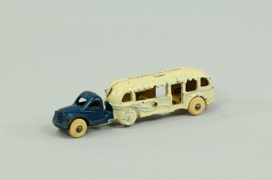 GREYHOUND BUS: Arcade, cast iron, smallest in series, integral cab, painted blue and white, roof stenciled "Greyhound Lines GMC," rubber tires . 5 5/8" l.