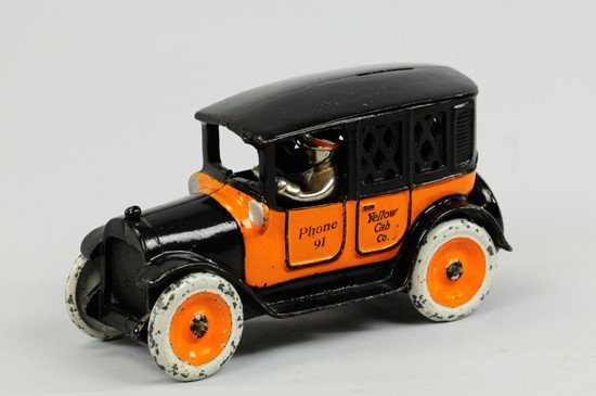 YELLOW CAB STILL BANK: Arcade, cast iron, painted in yellow and orange, doors stenciled 'Phone 91…Yellow Cab,' slot in roof, seated driver. 9" l.