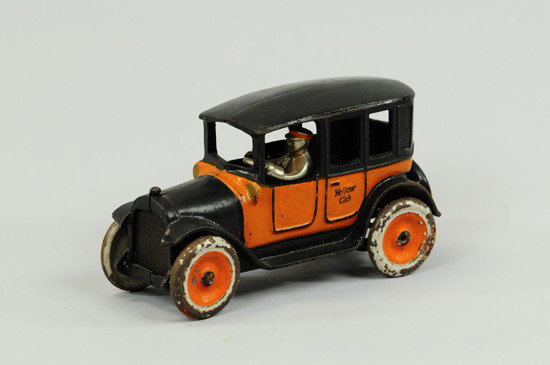 YELLOW CAB: Arcade, cast iron, painted in familiar orange and black colors, stenciled doors, mesh grille, disc wheels, nickel plated driver. 8 1/2" l.