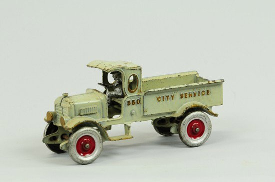 CITY SERVICE TRUCK: Kenton, cast iron, painted in grey overall with gold highlights, "550" in raised lettering on sides of cab, "City Service" on bed, solid silver painted wheels with red centers, removable driver. 8 1/2