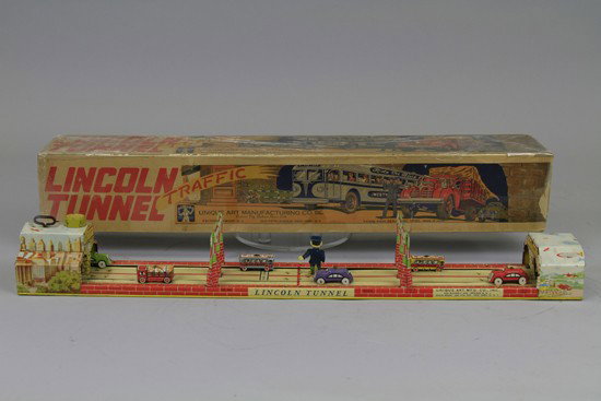 LINCOLN TUNNEL TOY: Unique Art, lithographed tin, depicts car and buses riding on road through NY and NJ on Lincoln Tunnel, clockwork driven. 24" l.