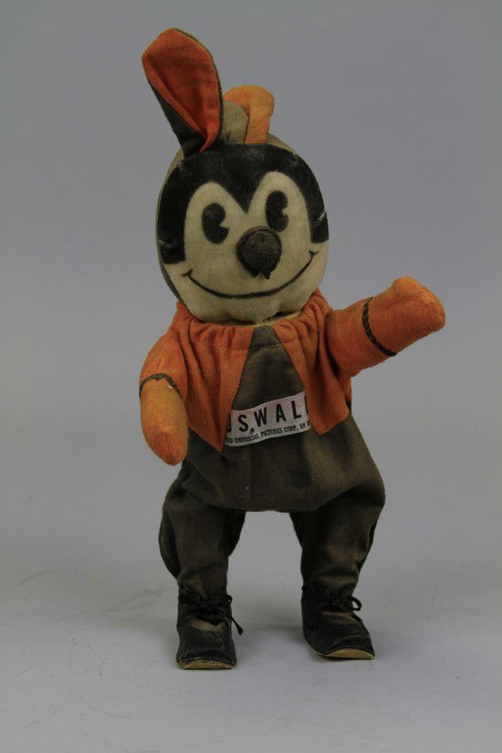 RARE OSWALD LUCKY RABBIT KEY WIND WALKER: C. 1930, Irwin, cloth belly tag reads "Oswald the Lucky Rabbit Copr. Universal Pictures," stuffed example. 15" to ears.