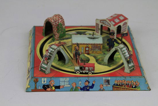 PINCHED WIND UP TOY: Louis Marx, lithographed tin clockwork, amusing graphics depicting traffic cop situations, one of many Marx table top games. 10" sq.