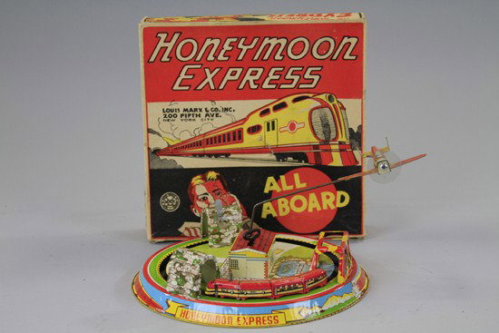 BOXED HONEYMOON EXPRESS: Marx Toys, lithographed tin, clockwork action allows train to circle tunnels and bridge. 9" dia.