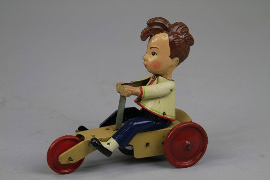 HEINI ON SCOOTER: Germany, rare tin lithographed example, c. 1930's, depicts boy on three wheel scooter, key wind up, very colorful and amusing caricature, rear plate reads "Heini 507," with two unfamiliar toy marks. 6