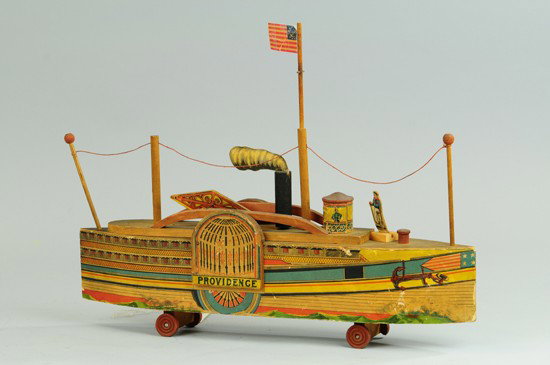 REED PROVIDENCE SIDE WHEELER RIVER BOAT: Scarce and colorful lithographed paper on wood, with paper decorated walking beam. Ex: Ward Kimball Collection. 20" l.