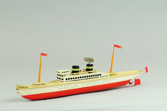 ARNOLD LINER: C. 1950's, lithographed tin, red and white hull, upper deck cabin with rows of lifeboats, clockwork driven, two masts and one flag. 17 1/2" l.