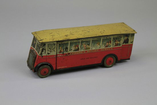 CRAWFORD'S SERVICE BUS BISCUIT TIN: England c. 1920 Tinplate with great lithographed images of passengers at the windows above which is marked "Crawford's Cream Crackers Crispy and Creamy," fitted with separate grille. 11 1/2" l.