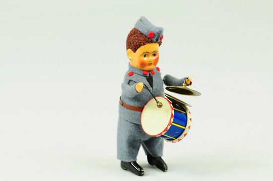 GERMAN BOY DRUMMER: Schuco, interesting wind up German boy figure, beats drum and walks when wound, wears felt uniform. 4 3/4" h.
