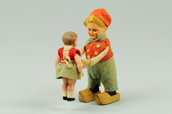 DUTCH DANCERS: Schuco, Germany, both wearing felt cultural outfits, girl made of celluloid head, hands and legs, boy wears wooden clogs, key wind operated.