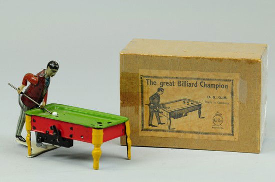 BOXED KICO BILLIARDS PLAYER: Germany, lithographed tin, depicts figure with cue stick in hand, table done in colorful green, red and yellow legs, clockwork driven stick action. 6" l.