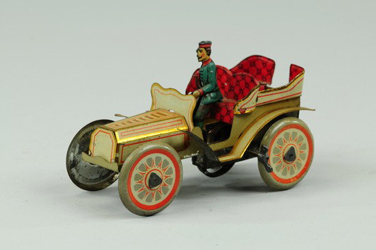 TONNEAU: Fischer, Germany, luxury auto with open seating and rear entrance, seated chauffeur, done in rich gold and red trim tin litho, clockwork mechanism.