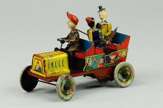 HANS EBERL "TA-RA-RA-BUMM" CLOWN CAR: Germany, c. 1920's, hand painted and lithographed tin, great graphic images surround tin open car with three seated clowns, each with hand painted head, one holds umbrella, one steers and one holds ca