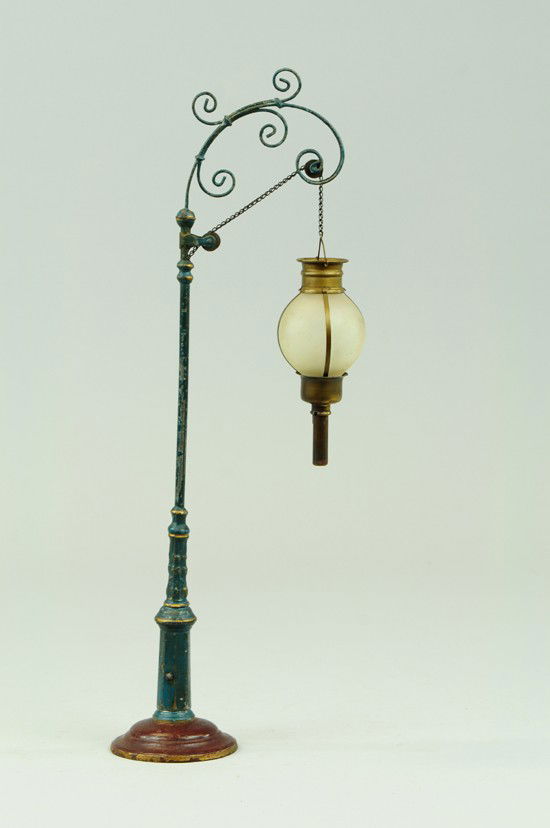 ARC LAMP: Marklin, Germany, cast pole with base, frosted glass globe supported on chain with crank for lowering and raising, ornate scroll work, early candle light example. 17 1/4" h.