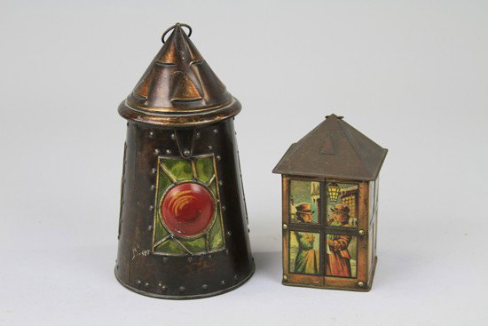 TWO "LANTERN" TINS: Lithographed tinplate. Comprising a Huntley and Palmer biscuit tin, c. 1911 in burnished copper with embossed rives and bull's eye lens. Together with a c. 1930 J. Lyons candy tin, the sides depict li