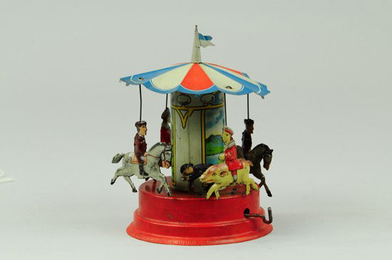 CAROUSEL: Gunthermann, Germany, lithographed tin, features four penny toy sized figures on pigs and horses, figure stands at base as if turning lever, clockwork allows spinning while sounds emit from base. 7 1/