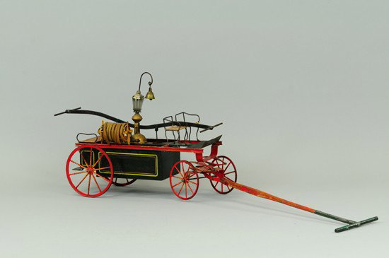 HAND FIRE PUMPER: Bing, Germany, c. 1900, hand painted in green body, high open bench seating, center mounted ornate lantern with bell, hose reel on side, large spoke wheels done in red, yellow highlights. 18" l.
