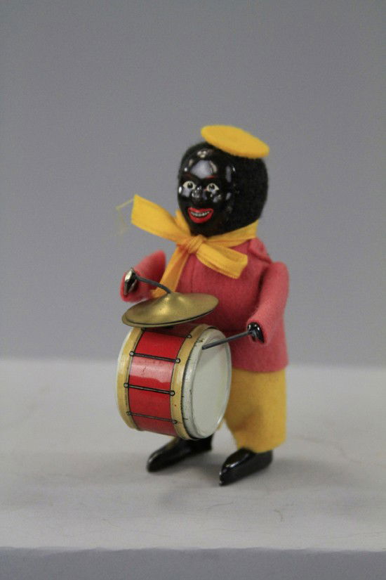 SCHUCO CLOWN DRUMMER: Germany, black tin face, full felt outfit, drum and cymbals appear at waist, clockwork driven. 5" h.