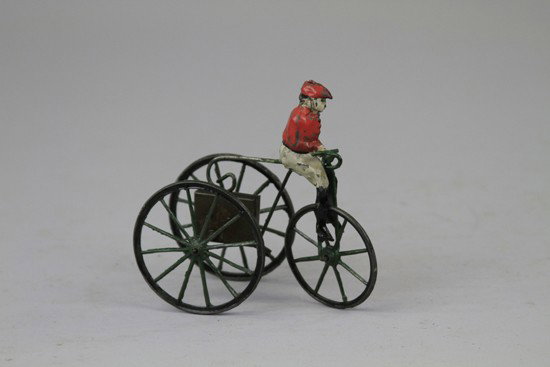 MAN ON THREE WHEELER: France, hand painted tin figure rides three wheel bike with clockwork mechanism, very early example. 4 3/4" l.