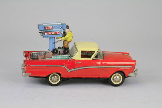 1957 FORD RANCHERO TELEVISION CAMERA MAN CAR: Joustra, France, rare tin car is friction but camera man is operated by key wind mechanism on side, very little wear overall, working. 11 1/2" l.