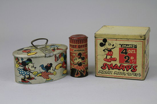 THREE MICKEY MOUSE TINS: Includes a white Sharp's Toffee Tin, a Saiva Biscuits oval lunch pail in silver and a pillar box, all feature great images of Mickey. 4" to 6 ½'.