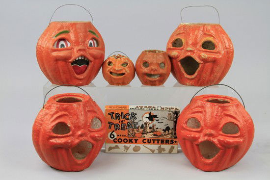 SIX PULP JACK-O-LANTERNS & COOKIE CUTTERS: CUTTERS Six USA jack-o-lanterns, one of which is two face, and trick or treat box of cookie cutters. 3 1/2" to 8".
