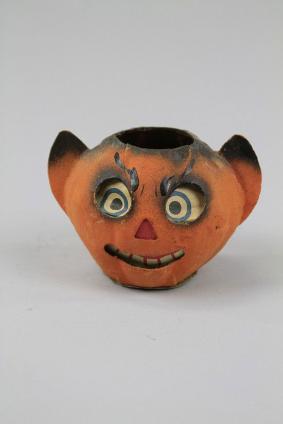 DEVIL EAR JACK-O-LANTERN: Marked Germany, a grinning paper face, devil ear jack-o-lantern with candle holder inside base. 3 1/4" h.