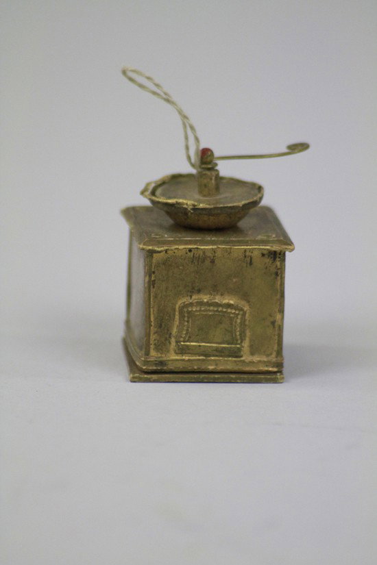 COFFEE GRINDER DRESDEN CANDY CONTAINER: Germany, painted in gold, nice example of old fashioned counter top coffee grinder, opens from the base. 1 1/2" h.