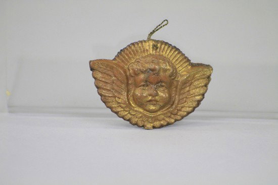 GOLD ANGEL HEAD DRESDEN ORNAMENT: A small two sided golden angel head Dresden Christmas tree ornament with fine molding throughout. 1 3/4" h.
