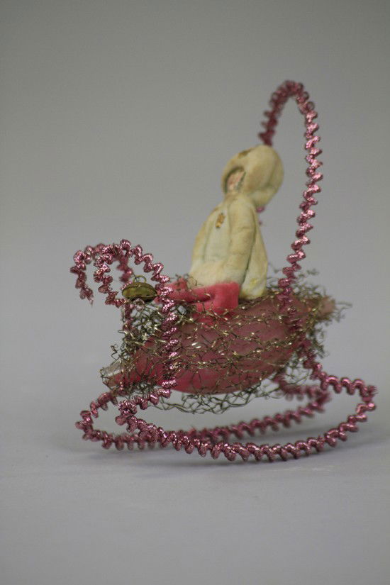 GIRL IN SLEIGH ORNAMENT: Germany, spun cotton girl with scrap face in wonderful wire wrap glass sleigh, a true center piece of someone's tree. 5" h.
