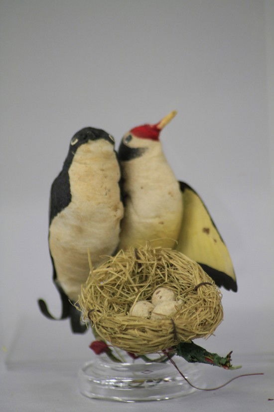 TWO BIRDS ON NEST ORNAMENT: Germany, two spun and pressed cotton birds, Dresden like paper wings and tails, hovering over nest of grass with three spotted eggs, birds show realistic detail overall with applied glass eyes to the