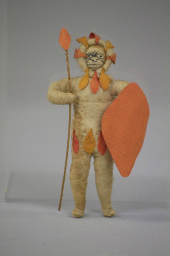 ZULU WARRIOR PRESSED COTTON ORNAMENT: Germany, fierce Zulu warrior with spear and shield, still retains good strong color and detail. 4 1/4" h.