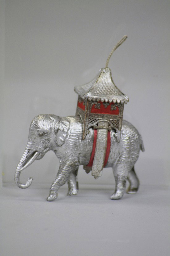 DRESDEN ELEPHANT WITH HOWDAH: Germany, realistic example of a silver elephant with finely detailed howdah with red silk curtains, this is one of the finest examples of the early Dresden ornaments to be found. 3 1/8" l.