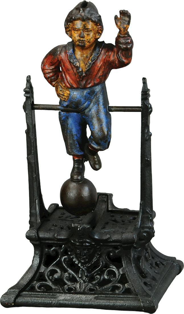 BOY ON TRAPEZE MECHANICAL BANK: 333. BOY ON TRAPEZE MECHANICAL BANK | Mfg. J. Barton Smith Co. | 9.5" h. | Base has been overpainted black, figure appears to be all original and should brighten up with a good cleaning, (Very Good Co