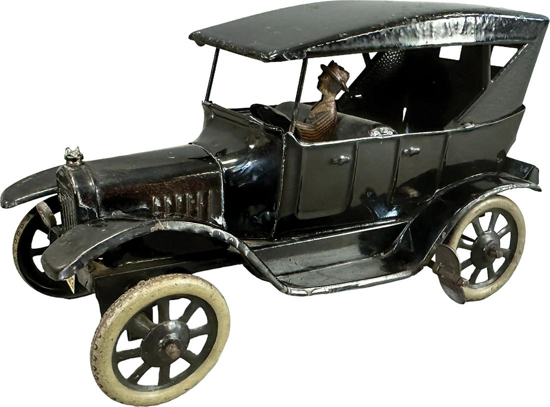 BING MODEL T FORD TOURING CAR: 19. BING MODEL T FORD TOURING CAR | Germany. Bing model T ford 4 door Touring car with driver, circa 1915, black with black spoke wheels, clockwork mechanism causes toy to move forward. | 6" l. | Mino