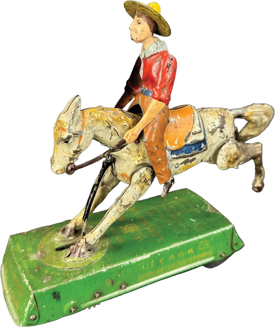LEHMANN BUCKING BRONCO: 25. LEHMANN BUCKING BRONCO | Germany. Wind-up causes toy to roll forward as horse kicks up and down throwing cowboy forth and back | 7" h. | Seam split at horses ankle, one arm is replaced and a spot 