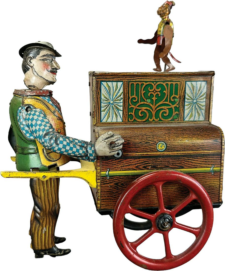 DISTLER WALKING ORGAN GRINDER: 158. DISTLER WALKING ORGAN GRINDER | Germany. A hard toy to find complete and original with the proper removable monkey. Wind-up causes toy to move forward as monkey on the top dances up and down | 8.