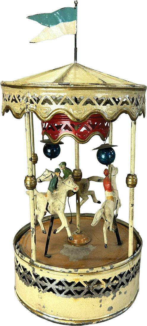 BING THREE HORSE CAROUSEL: 164. BING THREE HORSE CAROUSEL | Germany. Wind-up causes toy to revolve | 17" h. | Top of roof over-painted, otherwise all original in (Excellent Condition) | $350 - $700
