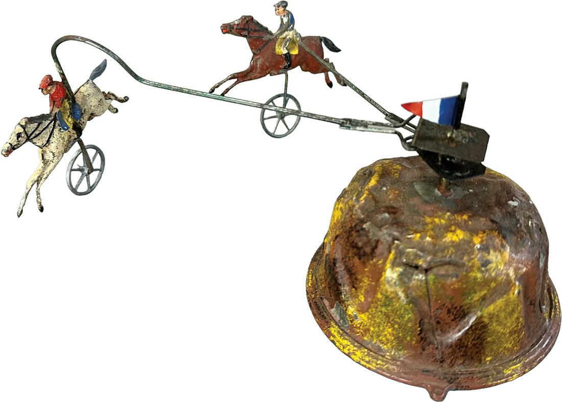 GERMAN WIND-UP CIRCLING HORSE RACE: 168. GERMAN WIND-UP CIRCLING HORSE RACE | Germany. Nice early example. Wind-up causes toy to revolve in a head to head horse race | 8" l. | Flag is added, otherwise all original in (Very Good Conditio