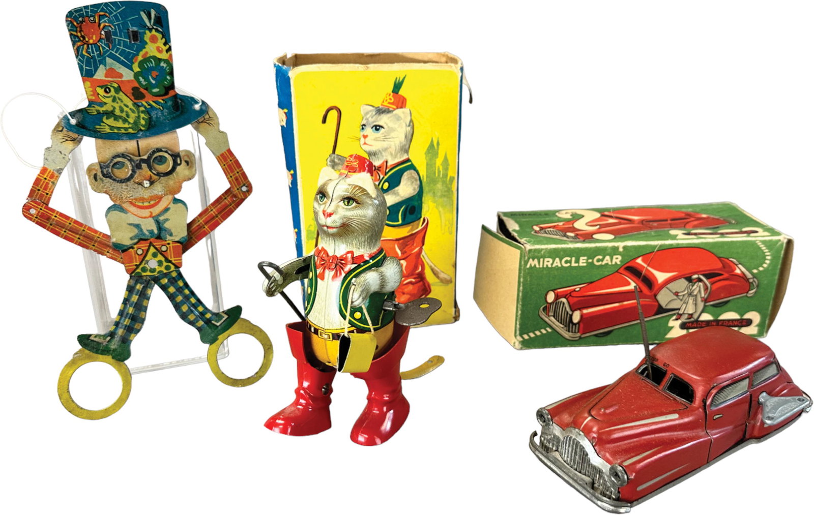 THREE SMALL ASSORTED EUROPEAN TOYS: 268. THREE SMALL ASSORTED EUROPEAN TOYS | 8" h. | Red car not working, auto missing one flap, cat missing one end, (Very Good to Excellent Condition) | $150 - $300