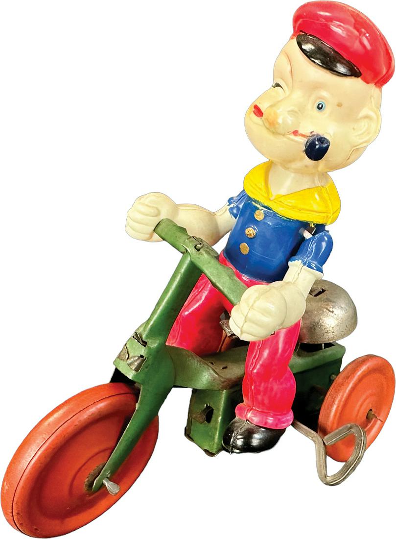 CELLULOID POPEYE TRICYCLE: 297. CELLULOID POPEYE TRICYCLE | Japan. Wind-up causes forward rolling and bell chime. | 5" l. | Possible celluloid repair to face at pipe, otherwise (Very Good Condition) | $100 - $200