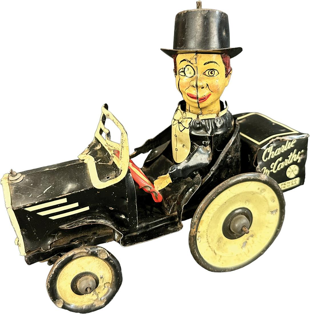 MARX CHARLIE MCCARTHY BENZINE BUGGY: 338. MARX CHARLIE MCCARTHY BENZINE BUGGY | USA. Wind-up causes toy to roll forward | 7" l. | Bending and denting to tin, all original and in working order. | $100 - $200