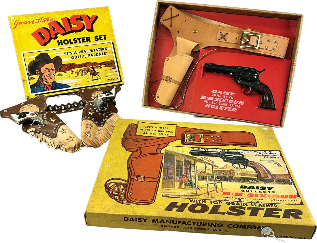 TWO BOXED DAISY GUN & HOLSTER SETS: 488. TWO BOXED DAISY GUN & HOLSTER SETS | 20" l. | Old store stock, minor wear to Daisy box, otherwise in All Original Condition. | $300 - $600