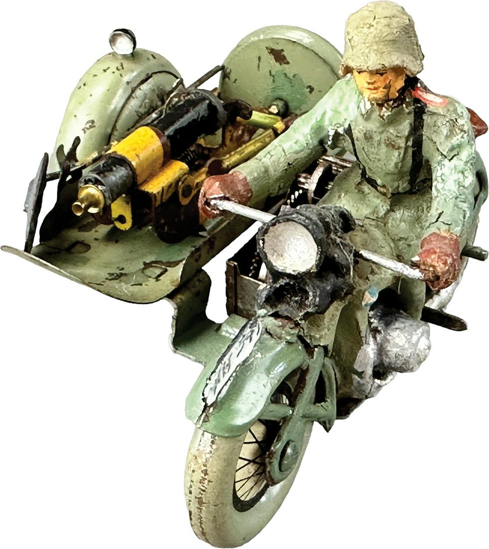 HAUSSER WIND-UP MOTORCYCLE: 1014. HAUSSER WIND-UP MOTORCYCLE | Germany. wind-up side car motorcycle carrying a heavy machine gun. | 5" l. | Motorcycle side car repainted, touch-up to original rider, wind-up motor working, overal