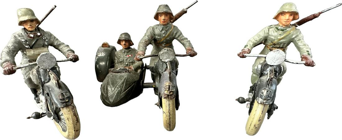 THREE LINEOL MILITARY MOTORCYCLES: 1047. THREE LINEOL MILITARY MOTORCYCLES | Germany. Two single motorcycles and one with side car. | 4"l. | Side car missing windshield, (Good to Very Good Condition) | $250 - $500