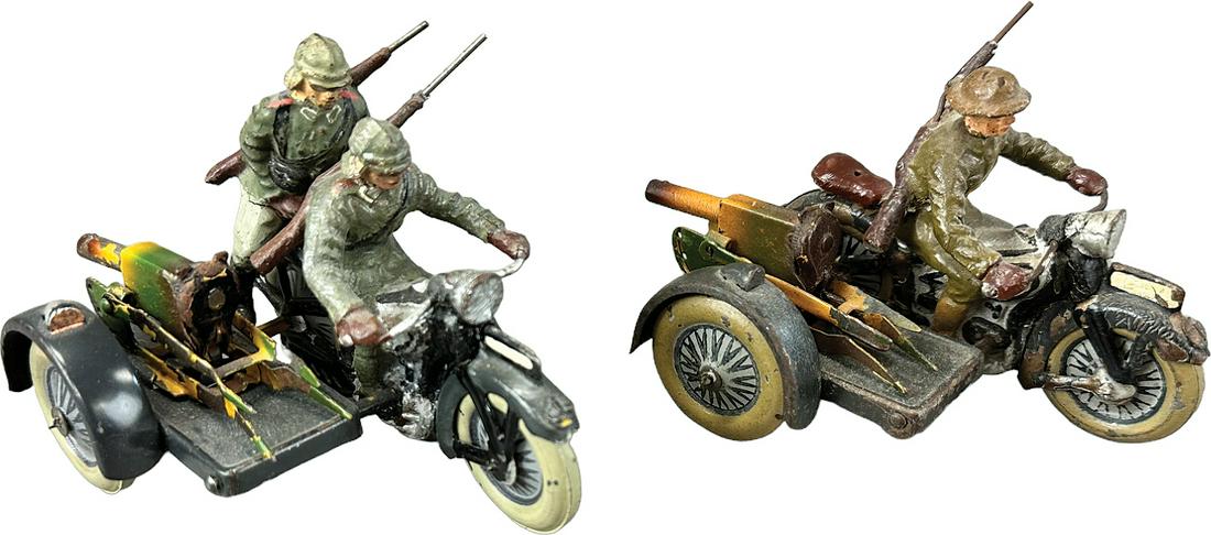 TWO LINEOL MOTORCYCLES W/ SIDE GUNS: 1062. TWO LINEOL MOTORCYCLES W/ SIDE GUNS | Germany. Wind-up One German and one British motorcycles. | 4" l. | (Very Good Condition) | $200 - $400