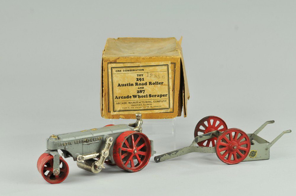 ARCADE "AUSTIN ROLL-A-PLANE" ROAD ROLLER W/SCRAPER: Boxed example, cast iron, painted in grey body, red rear spoke wheels and front roller, nickel plated standing driver. 7 3/4" l. (Exc. Cond.) 7 3/4" l.