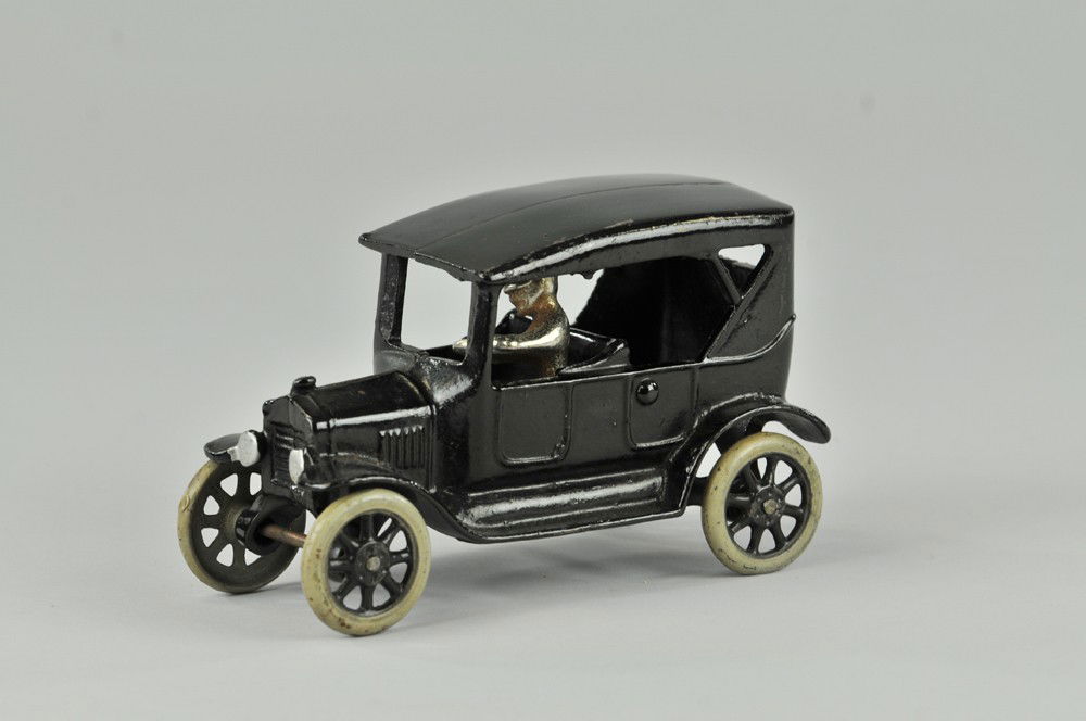 FORD MODEL "T" TOURING CAR: Arcade-1923 cast iron, painted in black overall, casting simulates soft top model, nickel plated driver, spoke wheels. 6 1/4" l. (Exc. Cond.) 6 1/4" l.