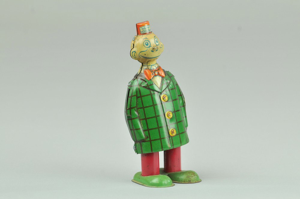 CHEIN HAPPY HOOLIGAN WALKER: Lithographed tin, colorful suited figure able to walk about when clockwork is activated. 6 1/4" h. Some scratches, overall (Exc. Cond.) 6 1/4" h.